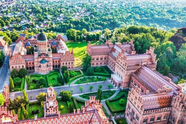Aerial view of Yuriy Fedkovych National University, Seminar Residence and Church of the Three Hierarchs. Old historical university building with towers, domes, and green garden Chernivtsi, Ukraine