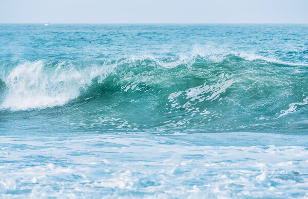 Wave splashing close-up. Crystal clear sea water, in the ocean in San Francisco Bay, blue water pastel colors.