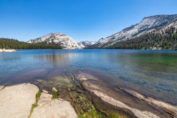 stock image Tenaya Lake in Yosemite National Park, California, shown in early morning against a clear, blue sky