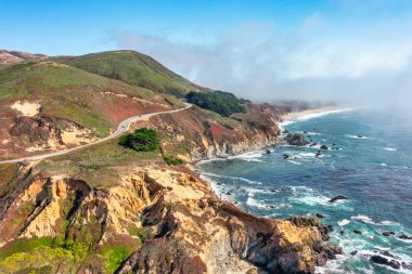 Beautiful landscape of Pacific Ocean coast along Highway 1 and Big Sur, aerial view, sunset, sunrise, fog. Concept, travel, vacation, weekend. clipart