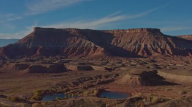 Çöl doğası ve kumtaşı erozyonunun fantastik antik manzarası. Zion Ulusal Parkı yakınlarındaki devasa kırmızı kaya oluşumlarının havadan görüntüsü. Turizm kavramı, seyahat. 4K video