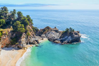 McWay Falls on Highway 1 and Big Sur along the Pacific Ocean coast, beautiful landscape and aerial view, sunset, sunrise, fog. Concept, travel, vacation, weekend. clipart