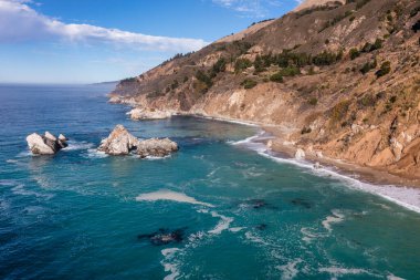 Highway 1 and Big Sur along the Pacific Ocean coast, beautiful landscape and aerial view, sunset, sunrise, fog. Concept, travel, vacation, weekend. clipart