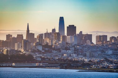San Francisco şehir merkezi Transamerica Piramidi ve Satış Gücü Kulesi ile gökyüzü manzaralı. Bulutlu gökyüzü, yoğun şehir mimarisi ve yüksek görüş açısına sahip deniz manzaralı binalar..