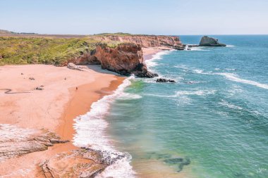 California 'daki Panther Sahili' nde turkuaz dalgalar, altın kum ve dramatik uçurumlar var. Açık bir bahar gününde yukarıdan görüldü.