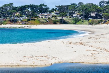 Carmel River State Beach in California USA with white sand, turquoise water, and calm lagoon at the river mouth, a scenic coastal destination for relaxation and photography