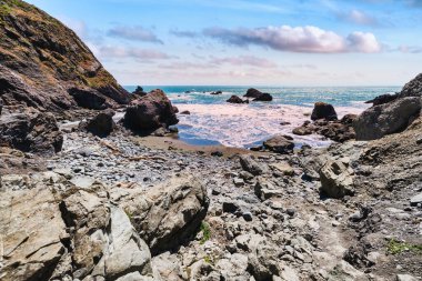 Rocky shoreline at Pirates Cove, reached via Tennessee Valley Trail in Marin Headlands, California. Rugged cliffs, boulders, and the Pacific Ocean waves create a wild coastal scene near San Francisco