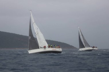 Bodrum,Turkey. 05 February 2023: Sailboats sail in windy weather in the blue waters of the Aegean Sea, on the shores of the famous holiday destination Bodrum.