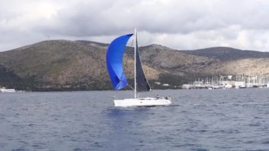 Bodrum, Hindi. 10 Mart 2023: Yelkenliler Ege Denizi 'nin mavi sularında, ünlü tatil beldesi Bodrum' un kıyılarında rüzgarlı havada yelken açıyorlar..
