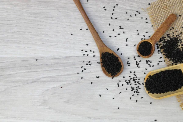 Black Cumin Seeds Essential Oil Bowl Wooden Shovel Spoon Nigella Royalty Free Stock Images