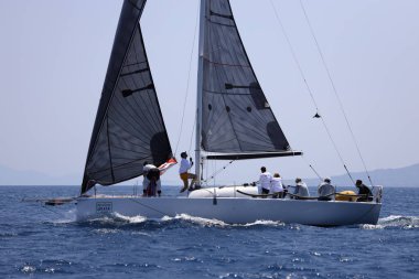 Bodrum, Hindi. 07 Mayıs 2023: Ege Denizi 'nin mavi sularında, ünlü tatil beldesi Bodrum' un kıyılarında yelkenliler rüzgarlı havada yelken açıyor.