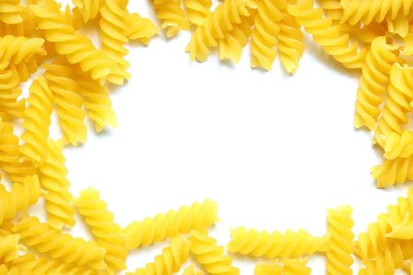 Frame Made Uncooked Fusilli Pasta Scattered White Table Mock Raw — Stockfoto