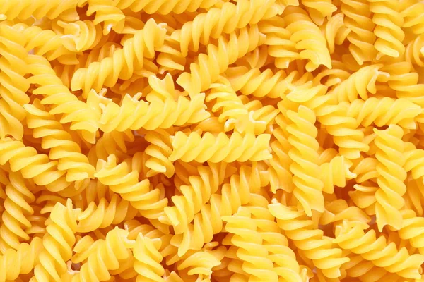 Uncooked Close Yellow Fusilli Pasta Background Spiral Raw Italian Pasta — Stock Photo, Image