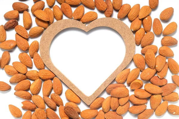 Almond heart on a white background. I love almonds. Healthy snack with nuts.