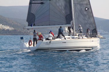 Bodrum, Hindi. 09 Şubat 2019: Yelkenliler Ege Denizi 'nin mavi sularında, ünlü tatil beldesi Bodrum' un kıyılarında rüzgarlı havada yelken açıyorlar..