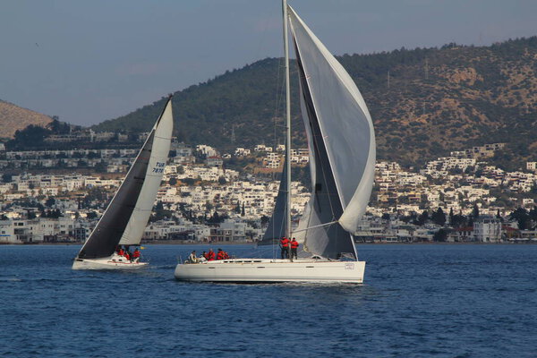 Bodrum,Turkey. 09 February 2019: Sailboats sail in windy weather in the blue waters of the Aegean Sea, on the shores of the famous holiday destination Bodrum.