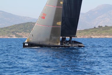 Bodrum, Hindi. 23 Mart 2019: Yelkenliler Ege Denizi 'nin mavi sularında, ünlü tatil beldesi Bodrum' un kıyılarında rüzgarlı havada yelken açıyorlar..