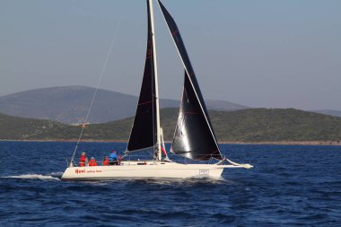Bodrum, Hindi. 23 Mart 2019: Yelkenliler Ege Denizi 'nin mavi sularında, ünlü tatil beldesi Bodrum' un kıyılarında rüzgarlı havada yelken açıyorlar..