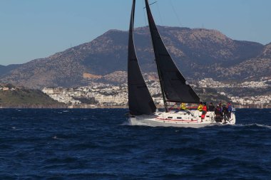 Bodrum, Hindi. 09 Şubat 2020: Ege Denizi 'nin mavi sularında, ünlü tatil beldesi Bodrum' un kıyılarında yelkenliler rüzgarlı havada yelken açıyor.
