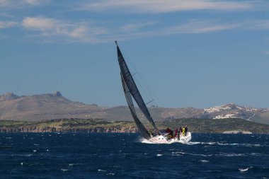 Bodrum, Hindi. 01 Mart 2020: Yelkenliler Ege Denizi 'nin mavi sularında, ünlü tatil beldesi Bodrum' un kıyılarında rüzgarlı havada yelken açıyor..