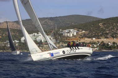 Bodrum, Hindi. 03 Aralık 2023: Yelkenliler Ege Denizi 'nin mavi sularında, ünlü tatil beldesi Bodrum' un kıyılarında rüzgarlı havada yelken açıyorlar..