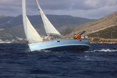 Bodrum, Hindi. 03 Aralık 2023: Yelkenliler Ege Denizi 'nin mavi sularında, ünlü tatil beldesi Bodrum' un kıyılarında rüzgarlı havada yelken açıyorlar..