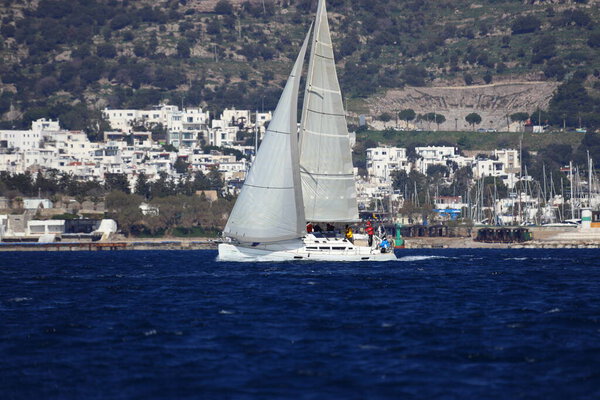 Bodrum,Turkey. 03 February 2024: Sailboats sail in windy weather in the blue waters of the Aegean Sea, on the shores of the famous holiday destination Bodrum.