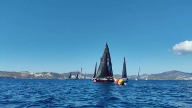Bodrum, Hindi. 23 Şubat 2024: Yelkenliler Ege Denizi 'nin mavi sularında, ünlü tatil beldesi Bodrum' un kıyılarında rüzgarlı havada yelken açtılar..