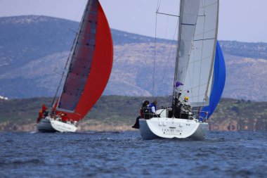 Bodrum, Hindi. 04 Şubat 2024: Ege Denizi 'nin mavi sularında, ünlü tatil beldesi Bodrum' un kıyılarında yelkenliler rüzgarlı havada yelken açıyor.