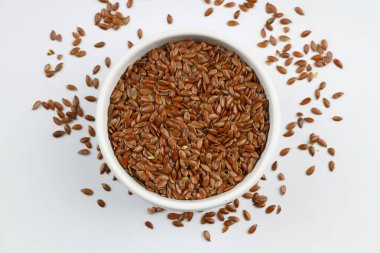 Pile of flax seeds isolated on white background clipart