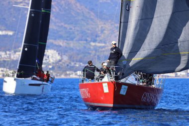 Bodrum, Hindi. 24 Şubat 2024: Ege Denizi 'nin mavi sularında, ünlü tatil beldesi Bodrum' un kıyılarında yelkenliler rüzgarlı havada yelken açıyor.