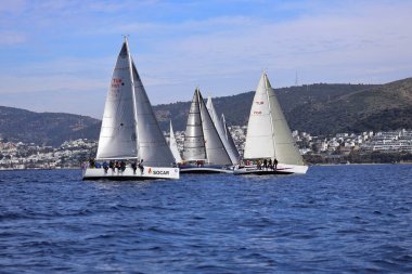 Bodrum, Hindi. 25 Şubat 2024: Ege Denizi 'nin mavi sularında, ünlü tatil beldesi Bodrum' un kıyılarında, rüzgarlı havada yelkenliler yelken açıyor.