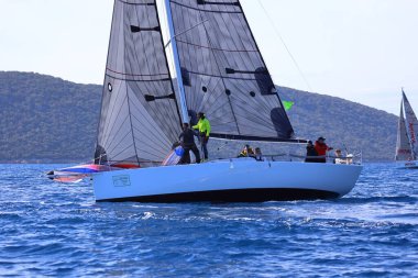 Bodrum, Hindi. 25 Şubat 2024: Ege Denizi 'nin mavi sularında, ünlü tatil beldesi Bodrum' un kıyılarında, rüzgarlı havada yelkenliler yelken açıyor.