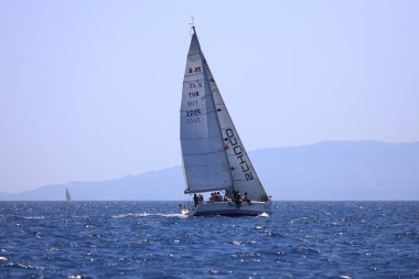 Bodrum, Hindi. 28 Nisan 2024: Yelkenliler Ege Denizi 'nin mavi sularında, ünlü tatil beldesi Bodrum' un kıyılarında rüzgarlı havada yelken açıyorlar..