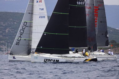Bodrum, Hindi. 26 Mayıs 2024: Yelkenliler Ege Denizi 'nin mavi sularında, ünlü tatil beldesi Bodrum' un kıyılarında rüzgarlı havada yelken açıyorlar..