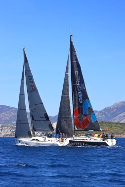 Bodrum, Hindi. 16 Mart 2024: Yelkenliler Ege Denizi 'nin mavi sularında, ünlü tatil beldesi Bodrum' un kıyılarında rüzgarlı havada yelken açıyorlar..