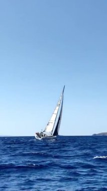 Bodrum, Hindi. 05 Ekim 2024: Yelkenliler Ege Denizi 'nin mavi sularında, ünlü tatil beldesi Bodrum' un kıyılarında rüzgarlı havada yelken açıyorlar. Sosyal medya için dikey video. 