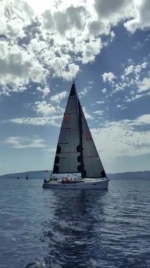 Bodrum, Hindi. 06 Ekim 2024: Yelkenliler Ege Denizi 'nin mavi sularında, ünlü tatil beldesi Bodrum' un kıyılarında rüzgarlı havada yelken açıyorlar. Sosyal medya için dikey video. 