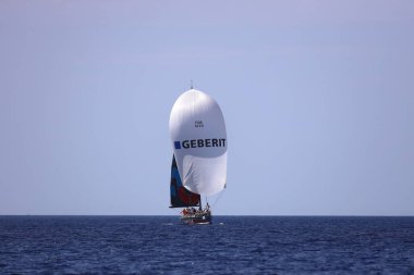 Bodrum,Turkey. 06 October 2024: Sailboats sail in windy weather in the blue waters of the Aegean Sea, on the shores of the famous holiday destination Bodrum. clipart