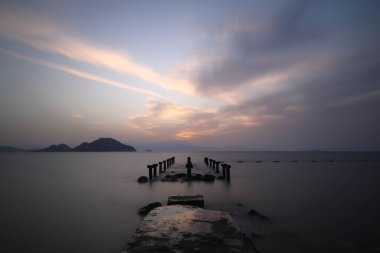 sunset on the beach. Seaside town of Turgutreis and spectacular sunsets. Selective Focus. Long Exposure shoot. tranquility scene. clipart