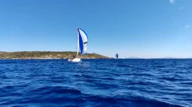 Bodrum, Hindi. 06 Ekim 2024: Yelkenliler Ege Denizi 'nin mavi sularında, ünlü tatil beldesi Bodrum' un kıyılarında rüzgarlı havada yelken açıyor.  