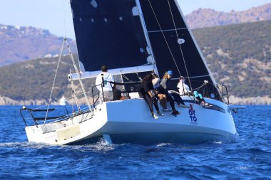 Bodrum, Hindi. 19 Ekim 2024: Yelkenliler Ege Denizi 'nin mavi sularında, ünlü tatil beldesi Bodrum' un kıyılarında rüzgarlı havada yelken açıyorlar..