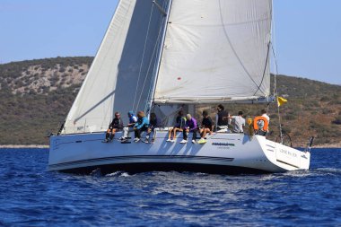 Bodrum, Hindi. 19 Ekim 2024: Yelkenliler Ege Denizi 'nin mavi sularında, ünlü tatil beldesi Bodrum' un kıyılarında rüzgarlı havada yelken açıyorlar..