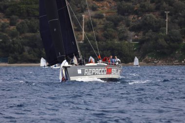 Bodrum,Turkey. 15 December 2024: Sailboats sail in windy weather in the blue waters of the Aegean Sea, on the shores of the famous holiday destination Bodrum. clipart