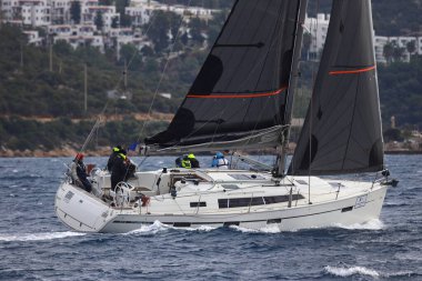 Bodrum, Hindi. 15 Aralık 2024: Yelkenliler Ege Denizi 'nin mavi sularında, ünlü tatil beldesi Bodrum' un kıyılarında rüzgarlı havada yelken açıyorlar..