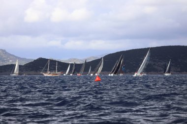Bodrum, Hindi. 11 Ocak 2025: Yelkenliler Ege Denizi 'nin mavi sularında, ünlü tatil beldesi Bodrum' un kıyılarında rüzgarlı havada yelken açıyorlar..
