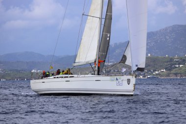 Bodrum,Turkey. 11 January 2025: Sailboats sail in windy weather in the blue waters of the Aegean Sea, on the shores of the famous holiday destination Bodrum. clipart