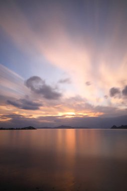 sunset on the beach. Seaside town of Turgutreis and spectacular sunsets. Selective Focus. Long Exposure shoot. tranquility scene. clipart