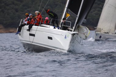 Bodrum, Hindi. 12 Ocak 2025: Yelkenliler Ege Denizi 'nin mavi sularında, ünlü tatil beldesi Bodrum' un kıyılarında rüzgarlı havada yelken açıyorlar..