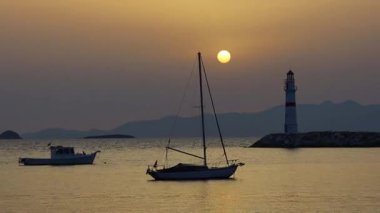 Gün batımında deniz manzarası. Sahildeki deniz feneri. Deniz kenti Turgutreis ve muhteşem gün batımları